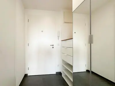 a room with white walls and a glass door at Vila Vinice in Prague