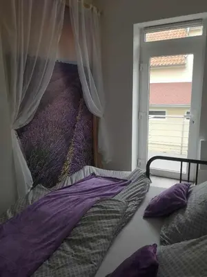 a bed in a bedroom with a window at Apartmán U vody in Županovice