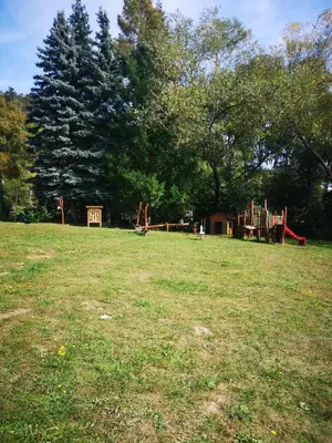 a park with a playground in a field with trees at Apartmán U vody in Županovice