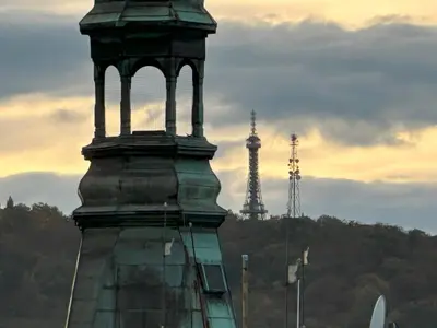 a tower with a clock on top of a building at Castle View Apartments. Old Town in Prague
