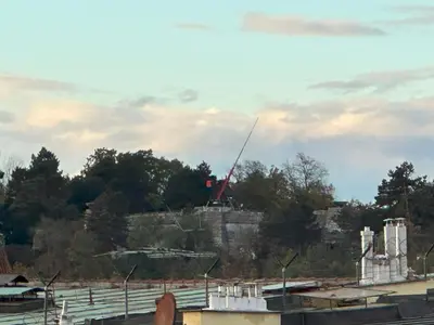 a building on a hill with a crane on it at Castle View Apartments. Old Town in Prague