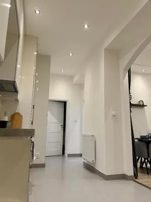 a white bathroom with a sink and a mirror at Modern flat in Central Prague in Prague