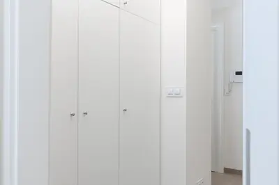 a row of white cabinets in a room at Bright aparment close to Wenceslas square with parking in Prague