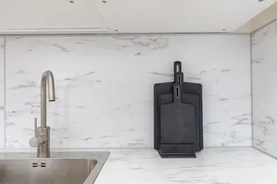 a kitchen counter with a knife holder on the wall at Bright aparment close to Wenceslas square with parking in Prague