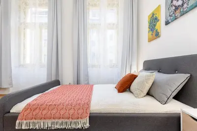 a bedroom with a bed with pillows on it at Bright aparment close to Wenceslas square with parking in Prague