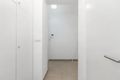 a room with white doors and a tile floor at Bright aparment close to Wenceslas square with parking in Prague