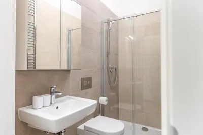 a bathroom with a sink and a toilet and a shower at Bright aparment close to Wenceslas square with parking in Prague