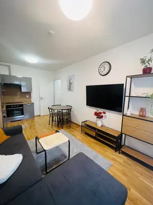 a living room with a couch and a table at Nika Apartments Prague 2 in Prague