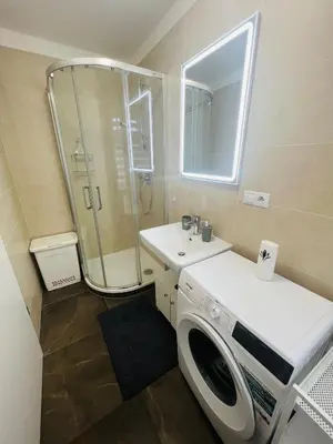a bathroom with a washing machine and a sink at Nika Apartments Prague 2 in Prague