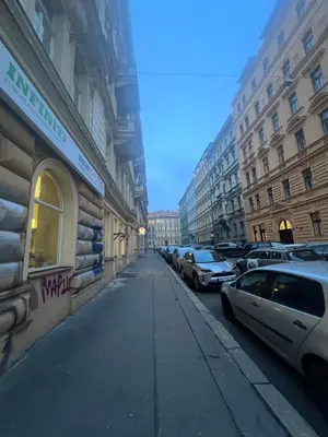 a city street with parked cars and buildings at Nika Apartments Prague 2 in Prague