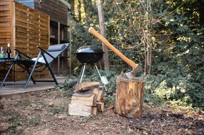 a grill with a bbq and a pan on it at CozyTiny house at lake with sauna in Řehenice