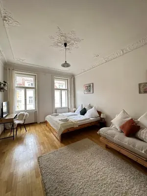 a living room with two beds and a couch at 3BDR Bohemian style central flat with Balcony in Prague