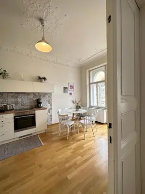 a kitchen and dining room with a table and chairs at 3BDR Bohemian style central flat with Balcony in Prague
