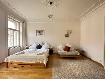 a bedroom with a bed and a couch at 3BDR Bohemian style central flat with Balcony in Prague