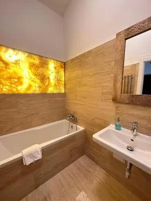 a bathroom with a white tub and a sink at 3BDR Bohemian style central flat with Balcony in Prague