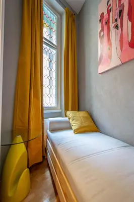 a bedroom with two beds and a glass table at 3BDR Oasis in the heart of Prague in Prague