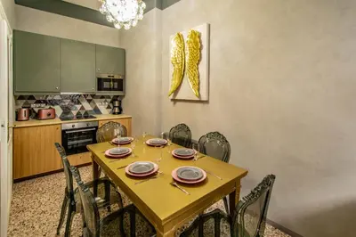 a dining room with a wooden table and chairs at 3BDR Oasis in the heart of Prague in Prague