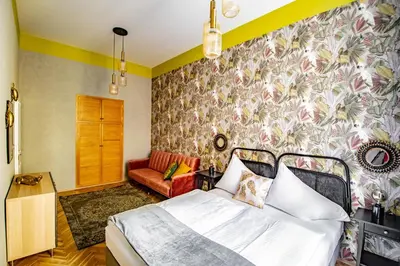 a bedroom with a bed and a couch at 3BDR Oasis in the heart of Prague in Prague
