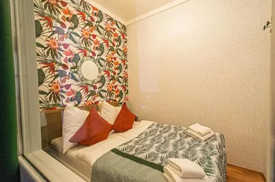 a small room with a bed with a mirror at Main Prague Square apartments Sauna and Fireplace in Prague
