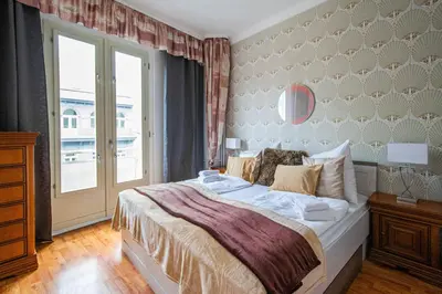 a bedroom with a large bed and a window at Main Prague Square apartments Sauna and Fireplace in Prague