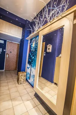 a room with a christmas tree mural on the wall at Main Prague Square apartments Sauna and Fireplace in Prague