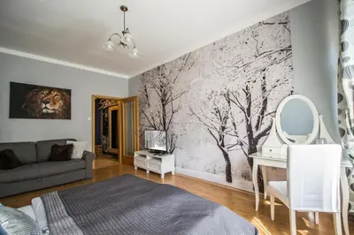 a living room with a couch and a desk at Main Prague Square apartments Sauna and Fireplace in Prague