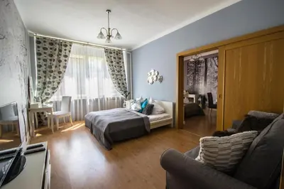 a bedroom with a bed and a living room at Main Prague Square apartments Sauna and Fireplace in Prague