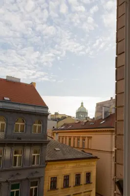 a view of the roofs of buildings in a city at Main Prague Square apartments Sauna and Fireplace in Prague