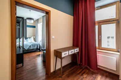 a bedroom with a bed and a table and a mirror at Wooden Design 2BDR Apartment near Eden Garden in Prague