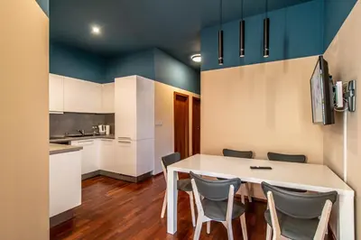 a kitchen with a white table and chairs at Wooden Design 2BDR Apartment near Eden Garden in Prague