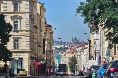 a busy city street with cars parked on the street at Artistic Designer Studio Žižkov in Prague