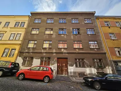 a red car parked in front of a building at Artistic Designer Studio Žižkov in Prague