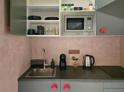 a kitchen with a sink and a microwave at Artistic Designer Studio Žižkov in Prague