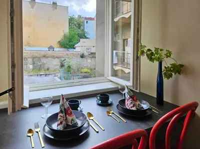 a table with two plates of food and a window at Artistic Designer Studio Žižkov in Prague