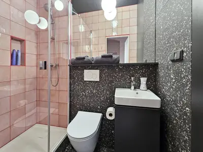 a bathroom with a toilet and a sink and a shower at Artistic Designer Studio Žižkov in Prague
