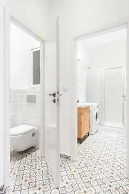 a white bathroom with a toilet and a sink at Prague Days - Eclectic Apartment in Trendy Area in Prague