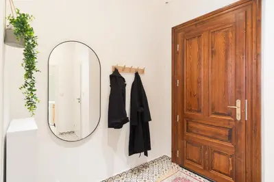 a mirror on a wall next to a door at Prague Days - Eclectic Apartment in Trendy Area in Prague