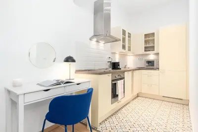 a kitchen with a desk and a blue chair at Prague Days - Eclectic Apartment in Trendy Area in Prague