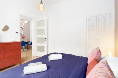 a bedroom with a blue bed with two towels on it at Prague Days - Eclectic Apartment in Trendy Area in Prague