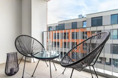 a bedroom with a large bed with white walls at Prague Days - Premium Apartments - Balcony in Prague