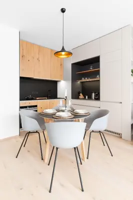 a kitchen with a dining room table and chairs at Prague Days - Premium Apartments - Balcony in Prague