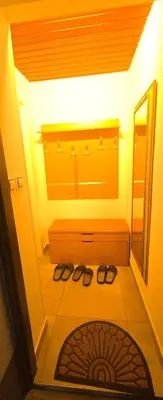 a bathroom with a mirror and a pair of shoes at Vu's Home in Prague