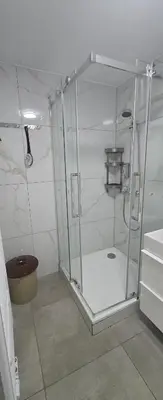 a shower with a glass enclosure in a bathroom at Vu's Home in Prague