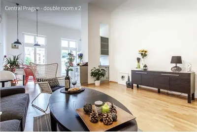 a living room with a couch and a table at Kent Ridge Loft in Prague