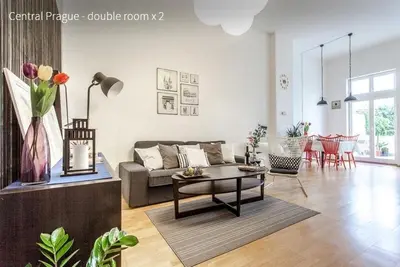 a living room with a couch and a table at Kent Ridge Loft in Prague