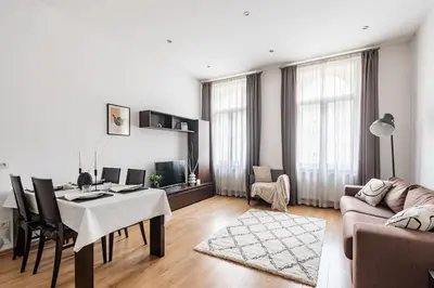 a living room with a table and a couch at Place of Grace - 50 Meters from Dancing House in Prague