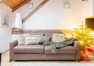 a living room with a couch and a christmas tree at Place of Grace - 50 Meters from Dancing House in Prague