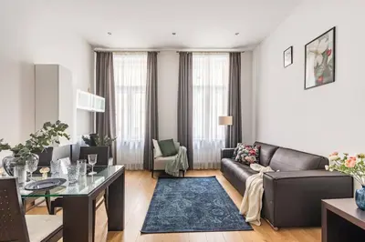 a living room with a couch and a table at Place of Grace - 50 Meters from Dancing House in Prague