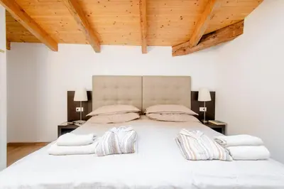 a bedroom with a large white bed with two pillows at Place of Grace - 50 Meters from Dancing House in Prague