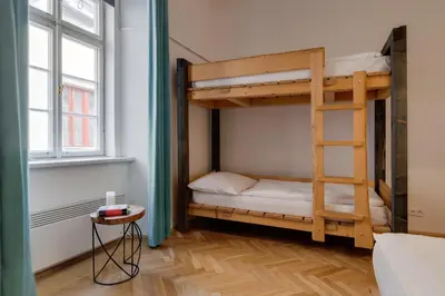 a bunk bed in a room with a ladder at Curiosity apartments in Prague